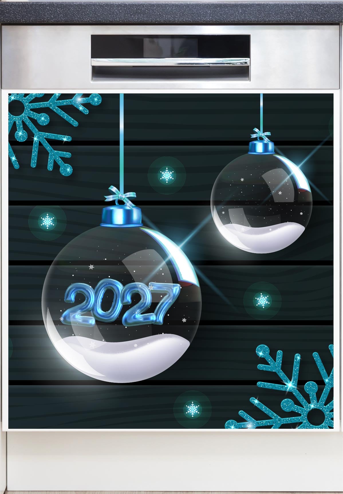A Decorative Dishwasher Magnet with a festive holiday-themed  print featuring two clear hanging Christmas ornaments with blue ribbons and snow-like white bottoms, one ornament displaying the year '2027' in glowing blue numerals. The background is a dark wood plank pattern with bright blue snowflakes and starburst accents.