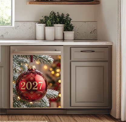 Custom printed holiday dishwasher magnet of a red 2027 Christmas ornament hanging on a tree, shown in a styled kitchen setting.