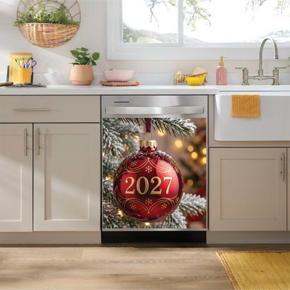 A stainless steel under-counter dishwasher set in a bright, modern kitchen, featuring a dishwasher magnet holiday graphic of a red ornament with gold details and the year '2027' on the door.